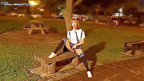 Asian girl with red hair is on the public with her feet